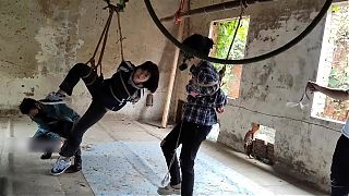 Two girls suspended in an abandoned house